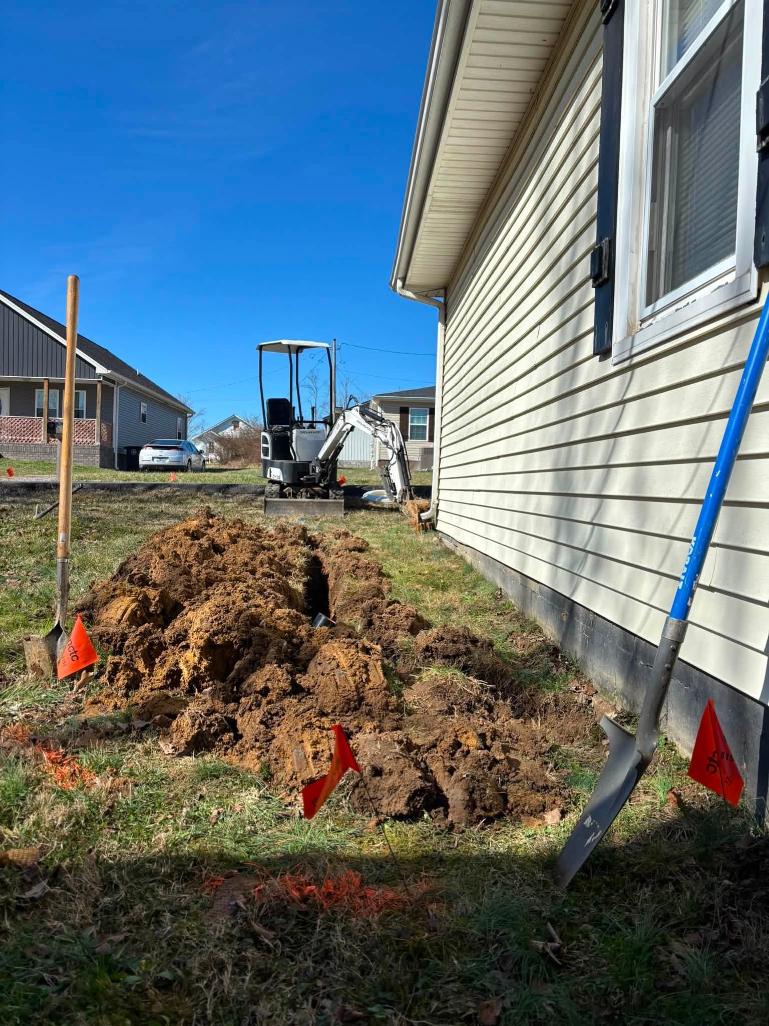K&S Contracting LLC excavator and trench work beside a Tennessee home